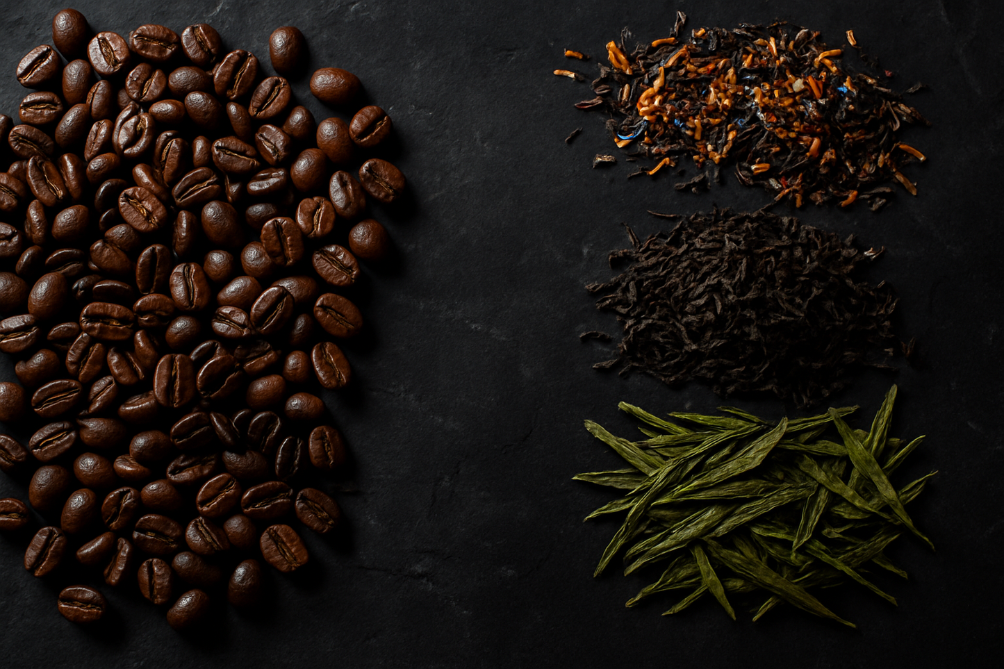 Coffee beans, dried herbs, and green tea leaves on a dark surface